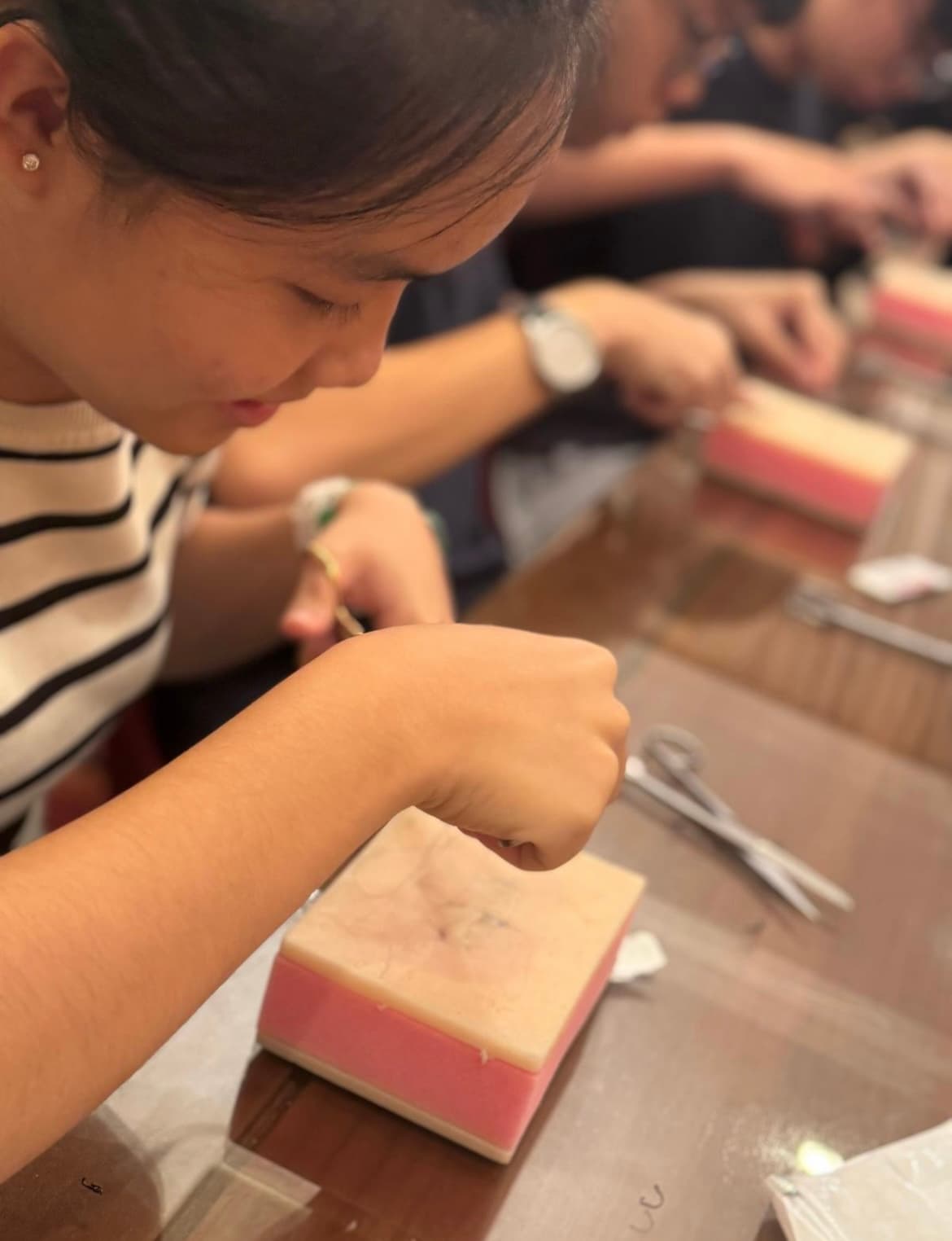 Practicing suturing on a pad